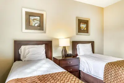 a room with two beds and a lamp on a table at Rivergrass 226 in Blue Mountains