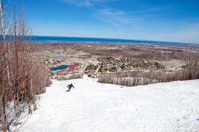 a person riding a snowboard down a snow covered slope at Condo 416 at North Creek Resort in Blue Mountains