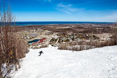 a person riding a snowboard down a snow covered slope at Condo 416 at North Creek Resort in Blue Mountains