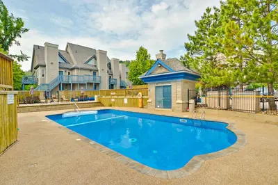 a large blue swimming pool in front of a house at Condo 416 at North Creek Resort in Blue Mountains