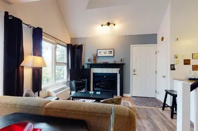 a living room with a couch and a fireplace at Condo 212 at North Creek Resort by Vacasa in Blue Mountains