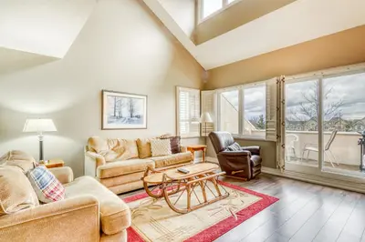 a living room with two couches and a table at Wintergreen 223 in Blue Mountains