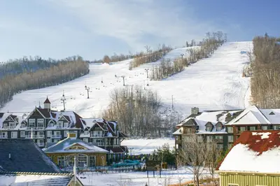 a town with a snow covered hill with a ski slope at Condo 807 at North Creek Resort in Blue Mountains