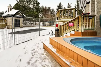a hot tub in a snow covered yard at Condo 816 at North Creek Resort in Blue Mountains