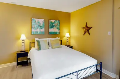 a bedroom with a large white bed with yellow walls at Condo 816 at North Creek Resort in Blue Mountains