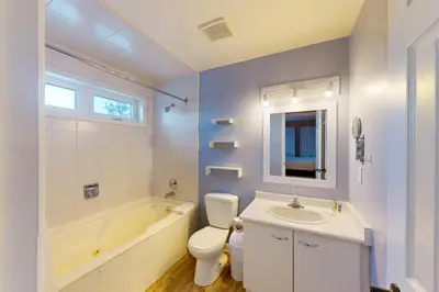 a bathroom with a sink and a toilet and a bath tub at Wintergreen 218 in Blue Mountains