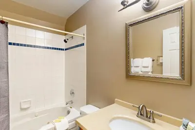 a bathroom with a tub and a sink and a mirror at Condo 614 at North Creek Resort in Blue Mountains