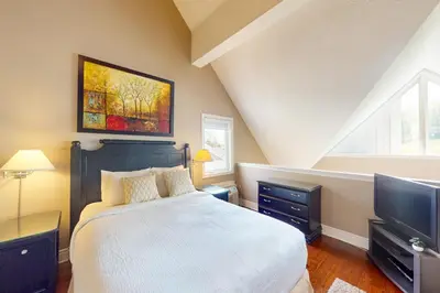 a bedroom with a large bed and a television at Condo 614 at North Creek Resort in Blue Mountains