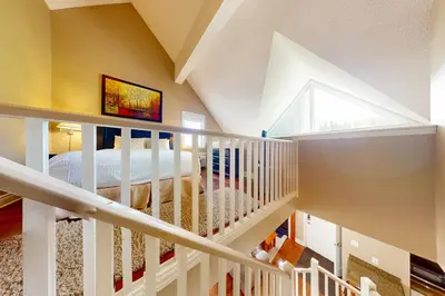 a white staircase with a bed in a room at Condo 614 at North Creek Resort in Blue Mountains