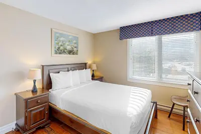 a bedroom with a white bed and a window at Wintergreen 202 in Blue Mountains
