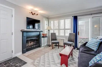 a living room with a couch and a fireplace at Mountainside Resort Condo at Blue in Blue Mountains