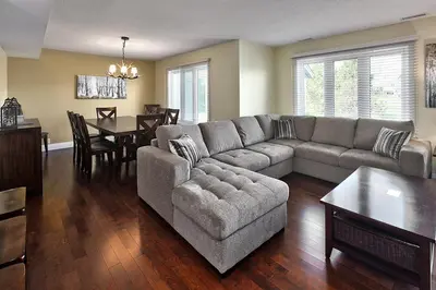 a living room with a couch and a dining room at Large luxurious upper floor condo in Sierra Lane in Blue Mountains