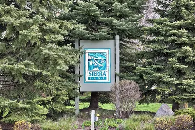 a sign in the middle of some trees at Large luxurious upper floor condo in Sierra Lane in Blue Mountains