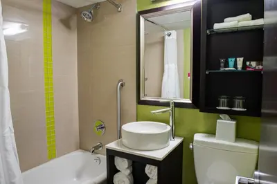 a bathroom with a sink and a toilet and a tub at Crowne Plaza Kitchener-Waterloo by IHG in Kitchener