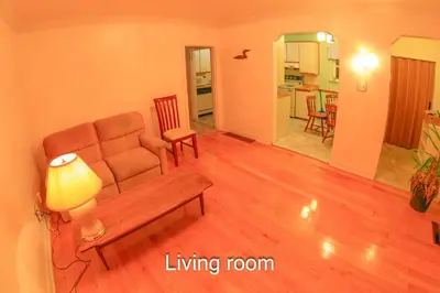 a living room with a couch and a living room with a table at Comfort Home Toronto in Toronto