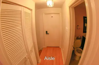 a hallway with a door and a toilet in a room at Comfort Home Toronto in Toronto