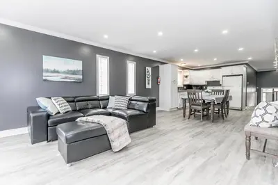 a living room with a couch and a table at Beach1 Riverfront Resort in Wasaga Beach