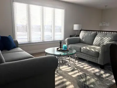 a living room with two couches and a glass table at Hammer Haus II in Waterloo