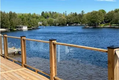a wooden deck with a view of a lake at Kawartha Lakes, Fenelon Falls in Fenelon Falls