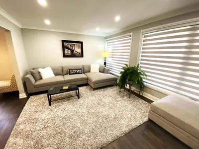 a living room with a couch and a table at iResidence in Toronto - Fantastic Vacation Home with Breakfast in Toronto