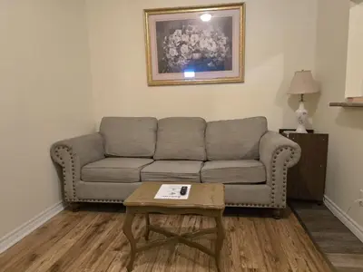 a living room with a couch and a coffee table at Capitol Suite in Niagara Falls