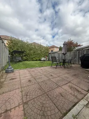 a patio with two chairs and an umbrella at Luxury Adventure, Rutherford Go station & Wonderland in Vaughan