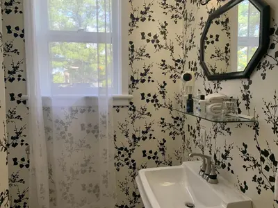 a bathroom with a sink and a mirror at Inn at the Falls in Bracebridge