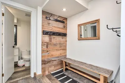 a bathroom with a bench and a mirror at 2 BR Ski In Out at Cachet Crossing, Sleeps 8 in Blue Mountains