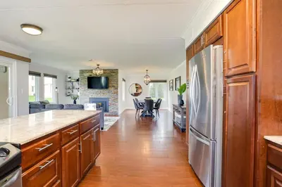 a kitchen with a refrigerator and a living room at Blue Mountain, 3 BR - 108 Mountain Walk Chalet in Blue Mountains