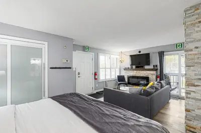 a bedroom with a bed and a living room at Blue Mountain Hideaway at North Creek Resort in Blue Mountains