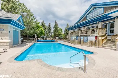 a swimming pool in front of a house at Blue Mountain Hideaway at North Creek Resort in Blue Mountains