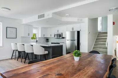 a kitchen and dining room with a wooden table at Ski in Ski Out Condo at Blue Mountain Close to Village in Blue Mountains