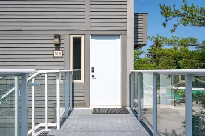 a white door on a house with a sign on it at Ski in Ski Out Condo at Blue Mountain Close to Village in Blue Mountains