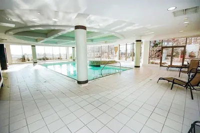 a large swimming pool in a building with a pool at PlanURstay - Ideal 2 BR & 2BTH 3888 Duke of York Blvd in Mississauga