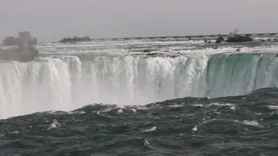 a large waterfall in the middle of a river at Boho Cottage - Hot tub and close to Beach in Fort Erie