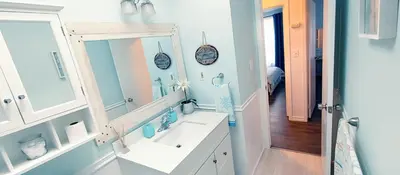 a bathroom with a sink and a mirror at Boho Cottage - Hot tub and close to Beach in Fort Erie