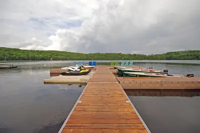 a dock with several boats on a lake at Ogopogo Resort in Carnarvon