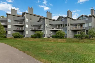 an apartment building with a lawn in front of it at Ski In Out 1 BR, Sleeps 6 Cachet Crossing in Blue Mountains