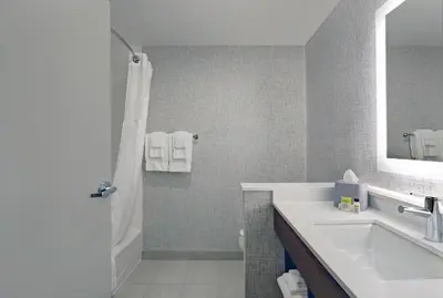 a bathroom with a sink and a shower and a mirror at Holiday Inn Express & Suites - Port Elgin in Port Elgin
