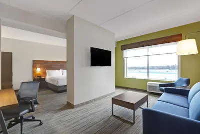 a hotel room with a couch and a bed and a tv at Holiday Inn Express & Suites - Port Elgin in Port Elgin
