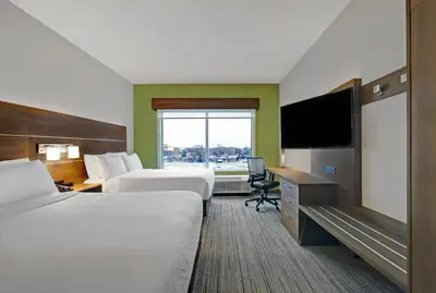 a hotel room with two beds and a flat screen tv at Holiday Inn Express & Suites - Collingwood in Collingwood