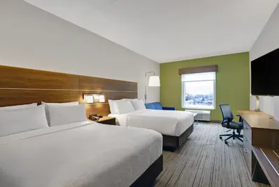 a hotel room with two beds and a television at Holiday Inn Express & Suites - Collingwood in Collingwood