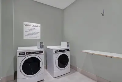 two washing machines and a washer and dryer in a room at Holiday Inn Express & Suites - Collingwood in Collingwood