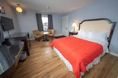 a hotel room with a bed with a red blanket at Choice Inn by the falls in Niagara Falls