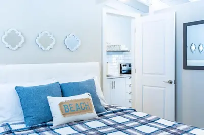 a bedroom with a bed with a blue and white blanket at Boutique Suite #7 in Blue Mountains