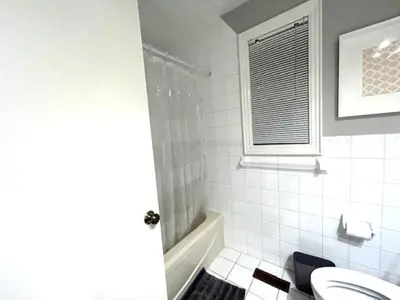 a bathroom with a shower and a toilet and a sink at Leslie in Wasaga Beach