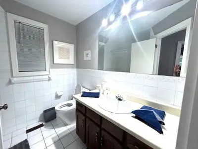 a bathroom with a sink and a toilet and a mirror at Leslie in Wasaga Beach