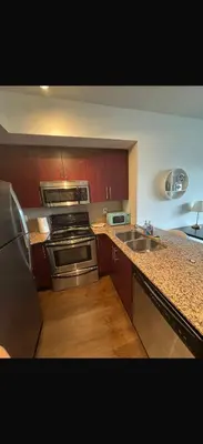 a kitchen with a stainless steel stove and a sink at Toronto CN Tower Maple Leaf Square Luxurious 2 Bedroom Condo in Toronto