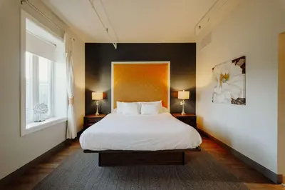 a bedroom with a white bed and two lamps at Mercer Hotel Downtown; BW Premier Collection in Stratford
