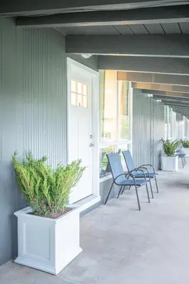 a porch with two chairs and a door on a house at 2BR Boutique Suite #8 in Blue Mountains